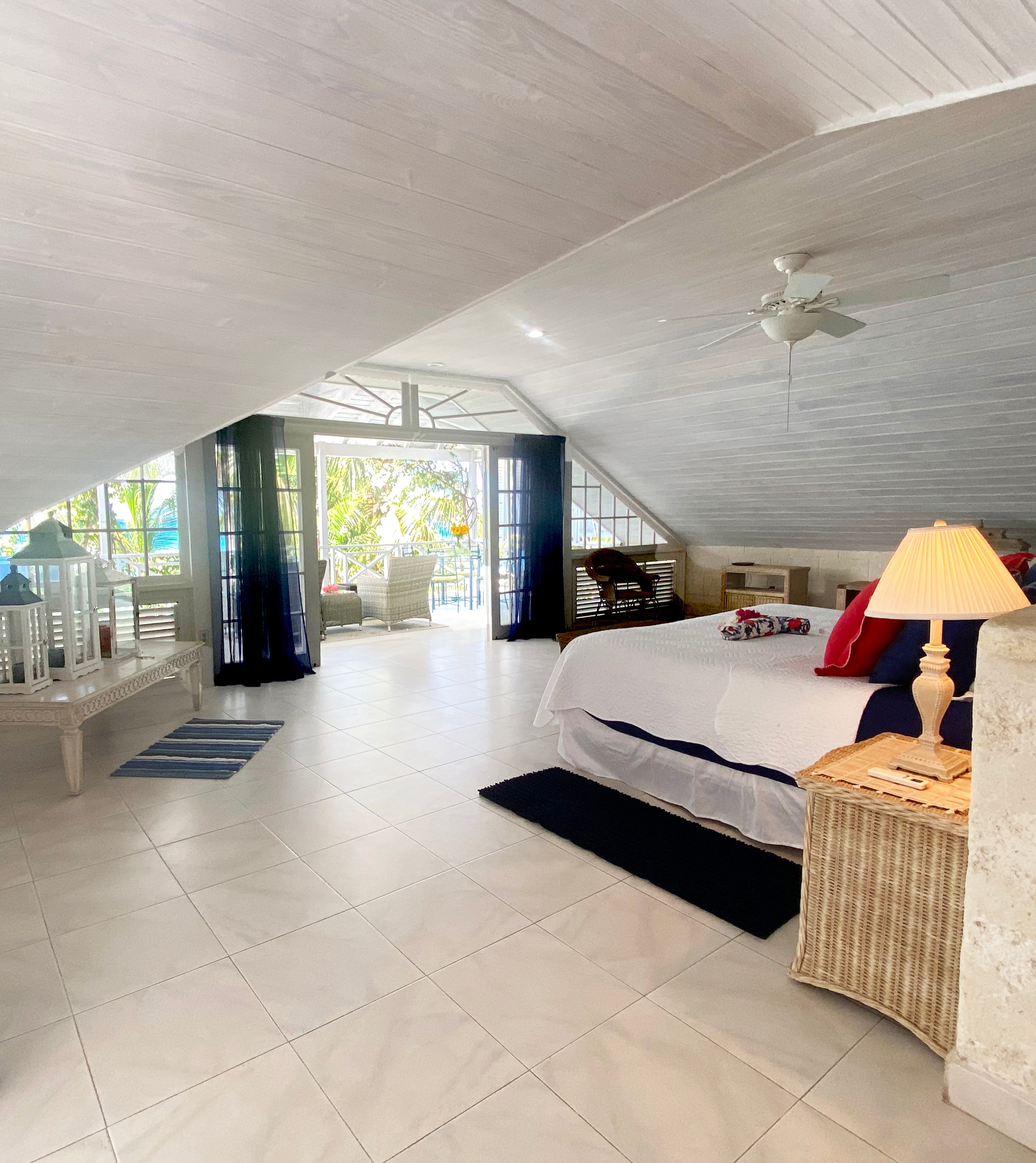 The primary bedroom at Tantalus Villa on Barbados West Coast has views overlooking the most beautiful beach with a large private terrace.